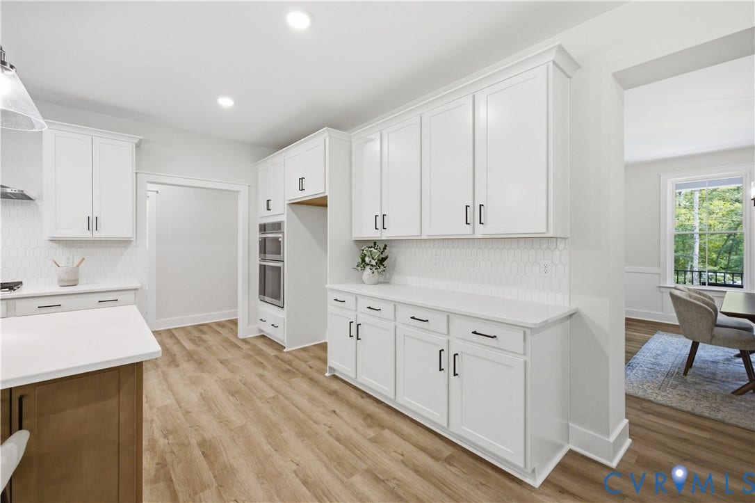 3120 Lake Stone (lot 22) Terrace, Maple Grove, Powhatan, VA 23139 Hall leads to a large pantry, laundry rm, garage entrance, 1st floor guest room, full bath. Photo of for-sale home, stagedhome, staged.