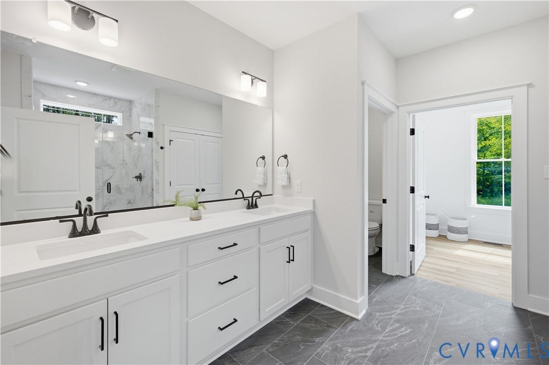 3120 Lake Stone (lot 22) Terrace, Maple Grove, Powhatan, VA 23139 Bathroom includes private water closet, tiled (to ceiling) shower with transom, linen, lare WIC. Photo of for-sale home, staged