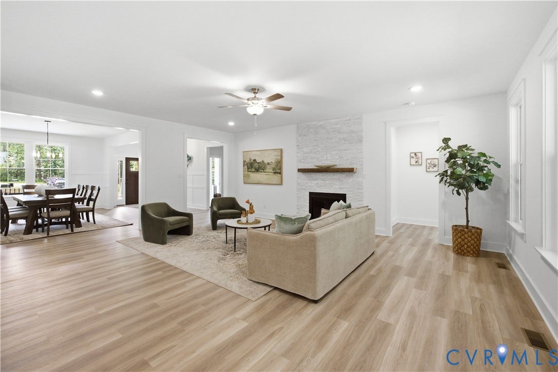 View to dining room, foyer and guest bedroom hall near the front. The rear hall is the vestibule to the primary bedroom. Photos of the for-sale home, staged.