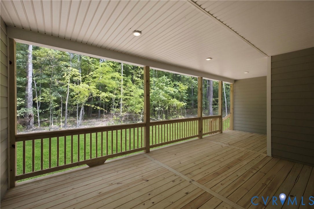 Rear covered porch, photos of the for-sale home.