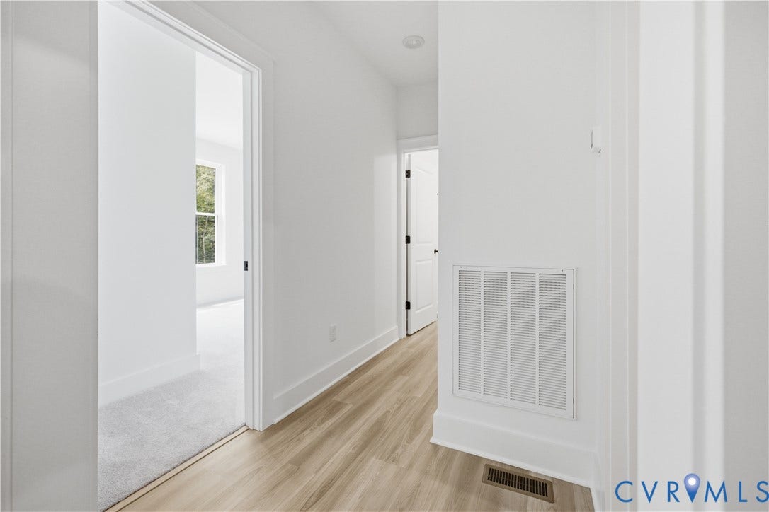 View to guest bedroom (4th bedroom), full bath down the hall, laundry to the right. Photos of the for-sale home.