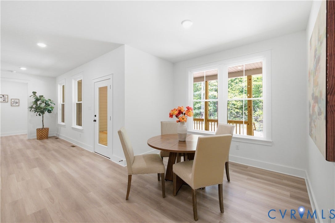 View to the family room and door to rear, covered porch. Photos of the for-sale home, staged.