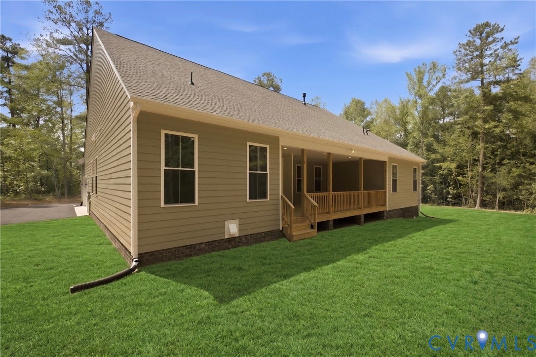 Rear view of home. Rear covered porch, photos of the for-sale home.