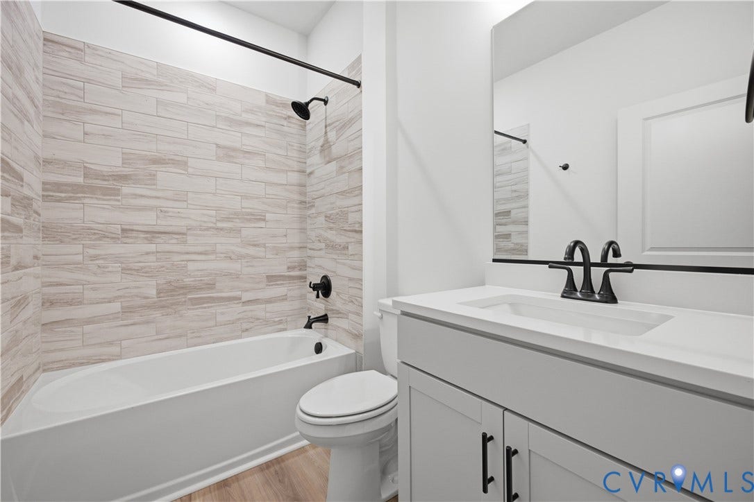 Full bath near bed 4. Photos of the for-sale home.