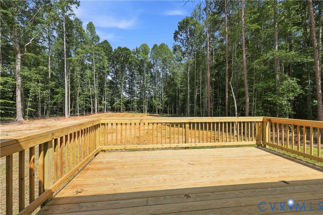 42 Clinton Farm Court, Clinton Farm, Cumberland, VA 23040 Expansive wooden deck with a complete railing system, overlooking a landscaped area and mature trees