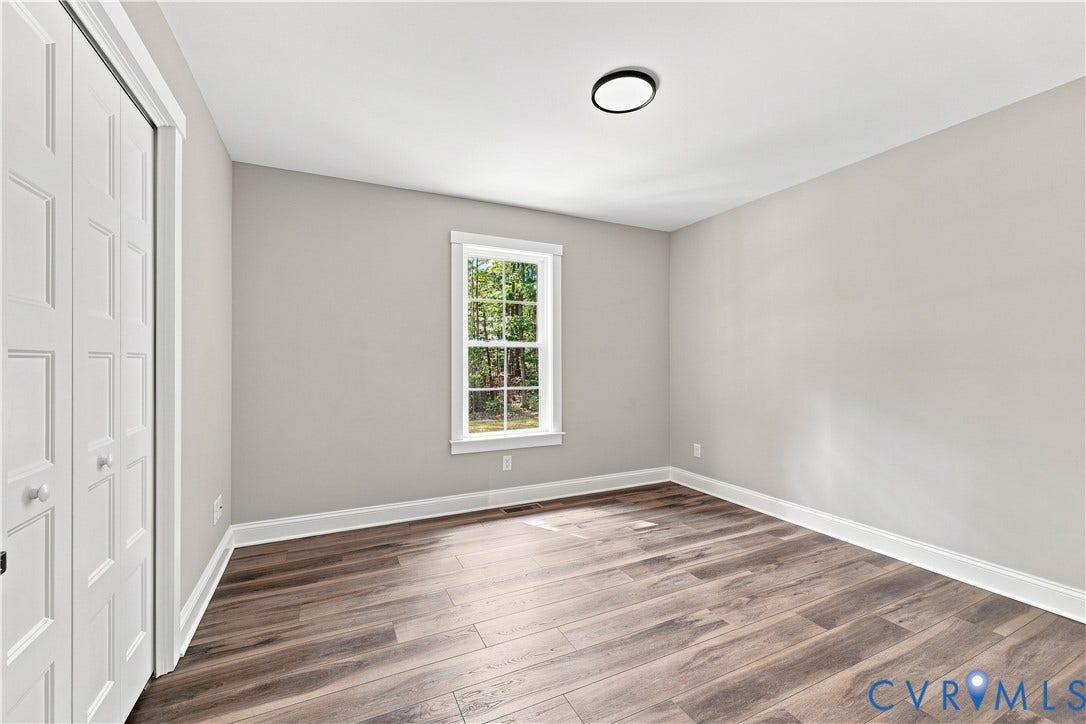 42 Clinton Farm Court, Clinton Farm, Cumberland, VA 23040 Wood-finish flooring, white trim, recessed window, and a built-in closet with bifold doors