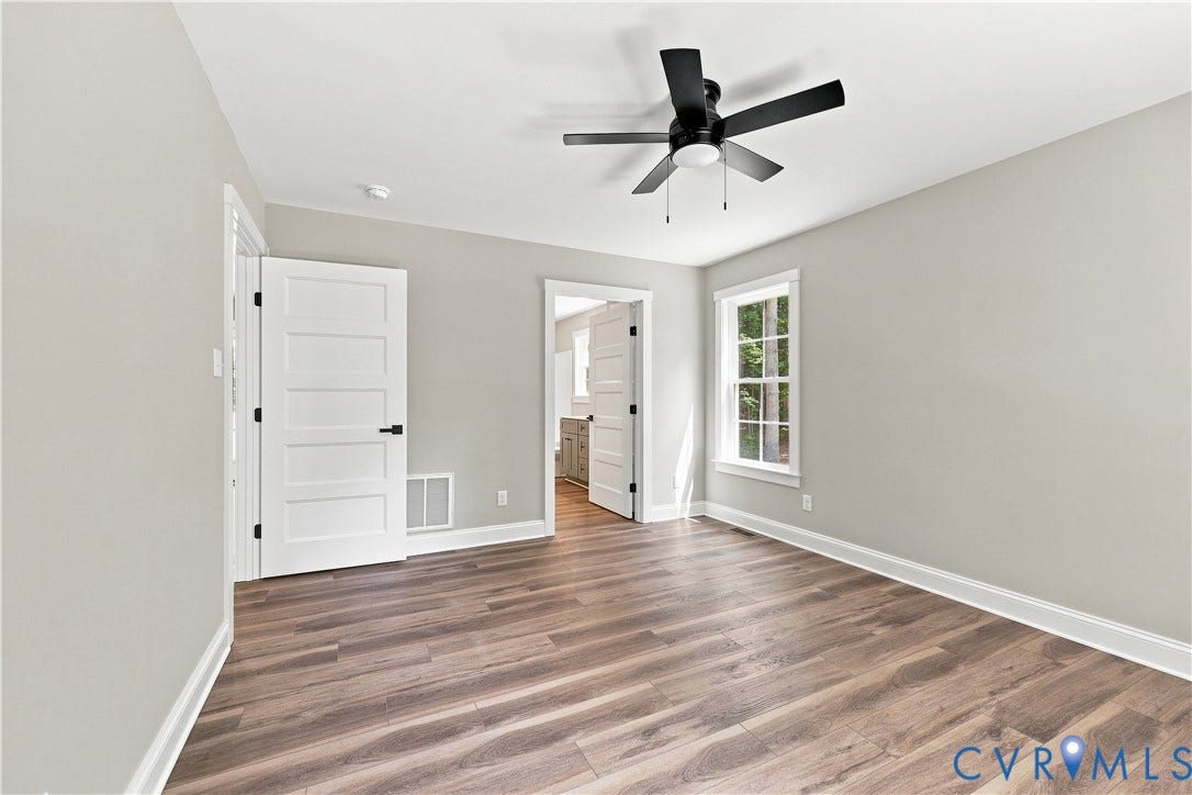 42 Clinton Farm Court, Clinton Farm, Cumberland, VA 23040 Wood-finish flooring, white trim, a ceiling fan, and a window with white casing