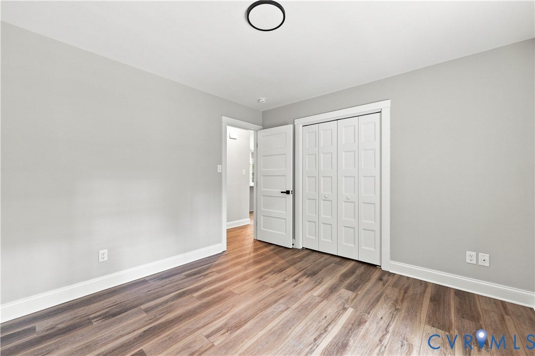 42 Clinton Farm Court, Clinton Farm, Cumberland, VA 23040 Wood-finish flooring with white trim, light gray painted walls, and a contemporary ceiling light fixture
