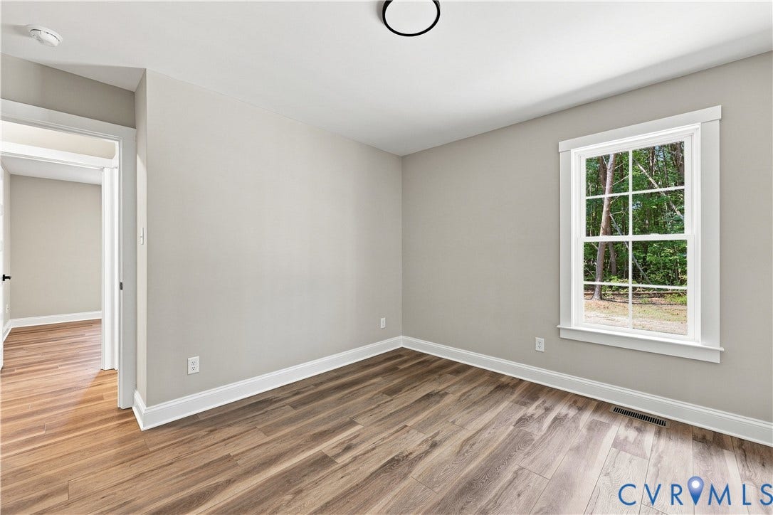 42 Clinton Farm Court, Clinton Farm, Cumberland, VA 23040 Wood-finish flooring, neutral wall tones, white trim, and a window with white casing
