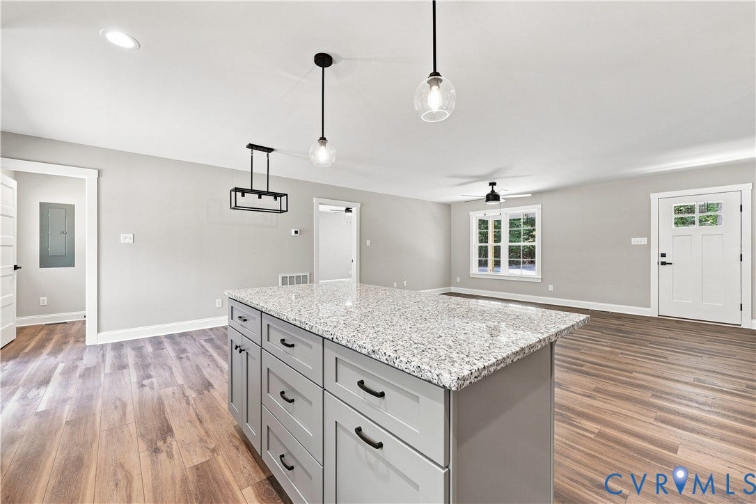 42 Clinton Farm Court, Clinton Farm, Cumberland, VA 23040 Kitchen island with a granite countertop and gray shaker-style cabinetry, complemented by wood-finish flooring