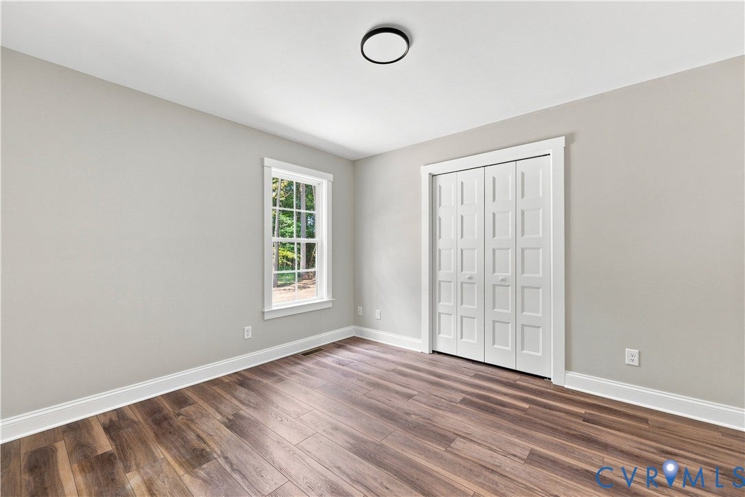 42 Clinton Farm Court, Clinton Farm, Cumberland, VA 23040 Wood-finish flooring, white trim, single window, white paneled bifold closet doors, and a flush mount ceiling light