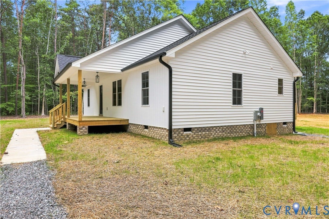 42 Clinton Farm Court, Clinton Farm, Cumberland, VA 23040 White siding exterior with a dark shingle roof, covered front porch, and a stone foundation