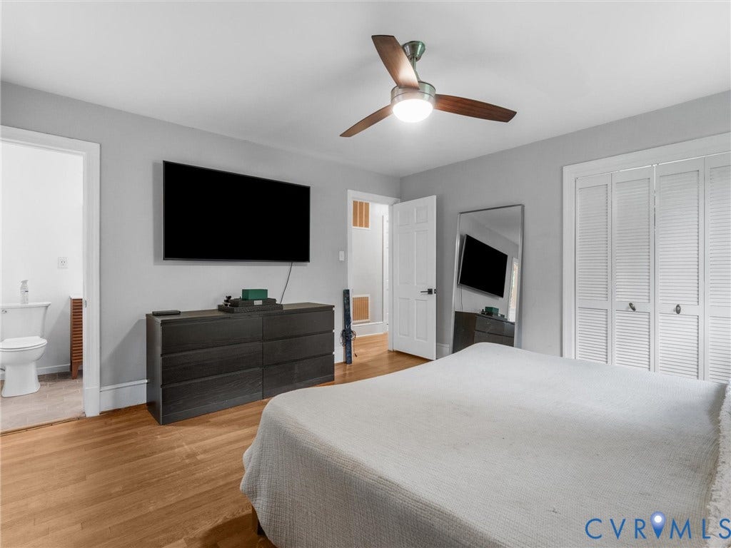 Hardwood flooring throughout, ceiling fan with integrated lighting, and louvered bi-fold closet doors