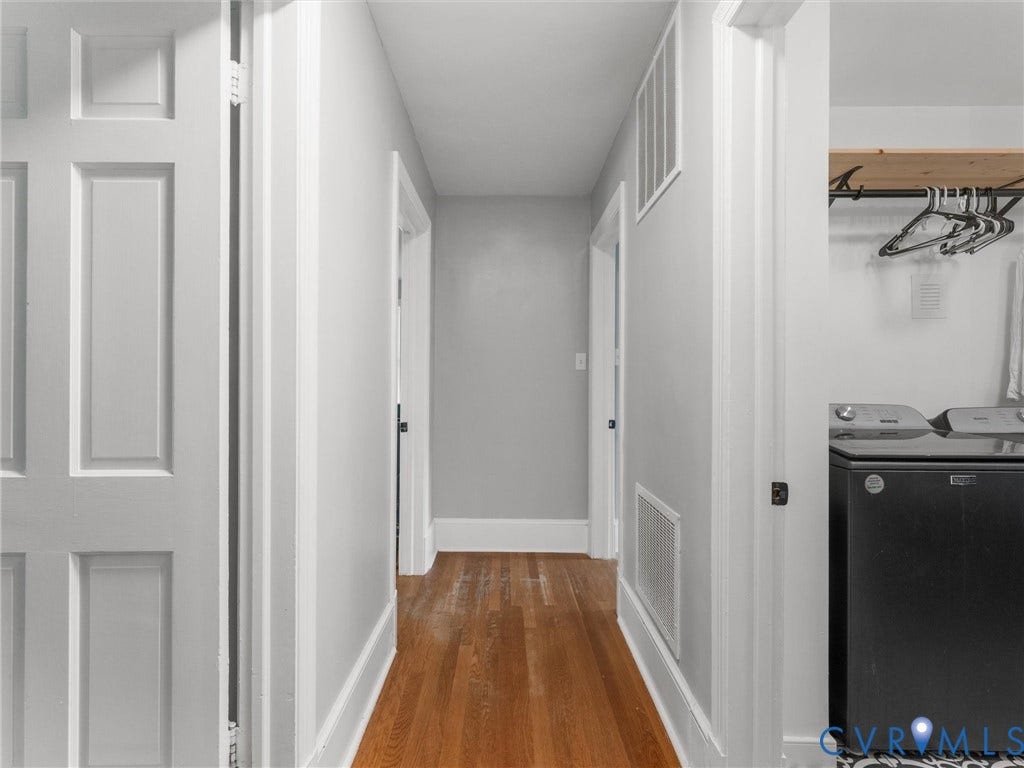 Hardwood flooring extending through the hallway