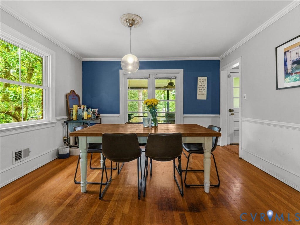 Hardwood flooring, painted walls with crown molding, chair rail molding, and a pendant light fixture