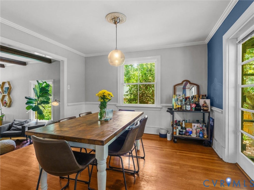 Hardwood flooring, crown molding, chair rail molding, ceiling medallion, and a glass-paned door