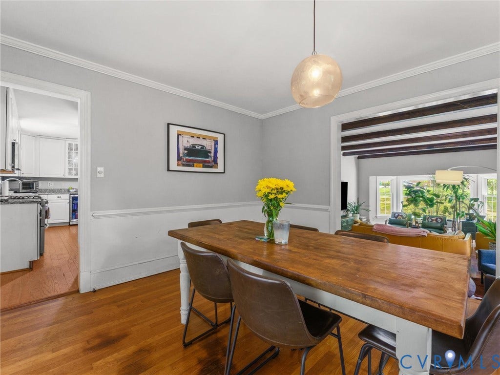 Hardwood flooring, crown molding, chair rail molding, and a distinctive pendant light fixture