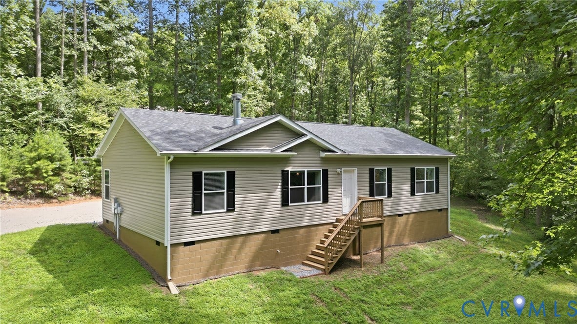 2575 Log Cabin Road, Maidens, VA 23102 Charming single-story home elevated on a concrete foundation with wooden decking and stairs to front entry.