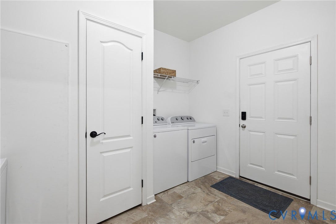 2575 Log Cabin Road, Maidens, VA 23102 Laundry area featuring light-toned tile flooring, a built-in wire shelf, and paneled doors with black hardware. Utility sink and closet.