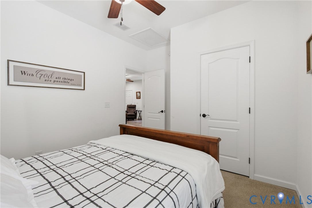 2575 Log Cabin Road, Maidens, VA 23102 Neutral tone wall paint, ceiling fan with wood-finish blades, and a textured carpeted floor