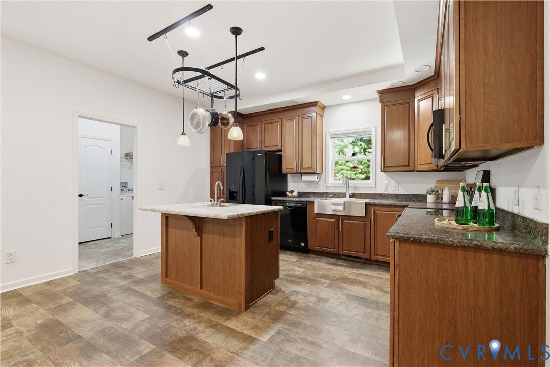 2575 Log Cabin Road, Maidens, VA 23102 Kitchen featuring wood-finish flooring, a central island with countertop, recessed lighting, and a farmhouse sink