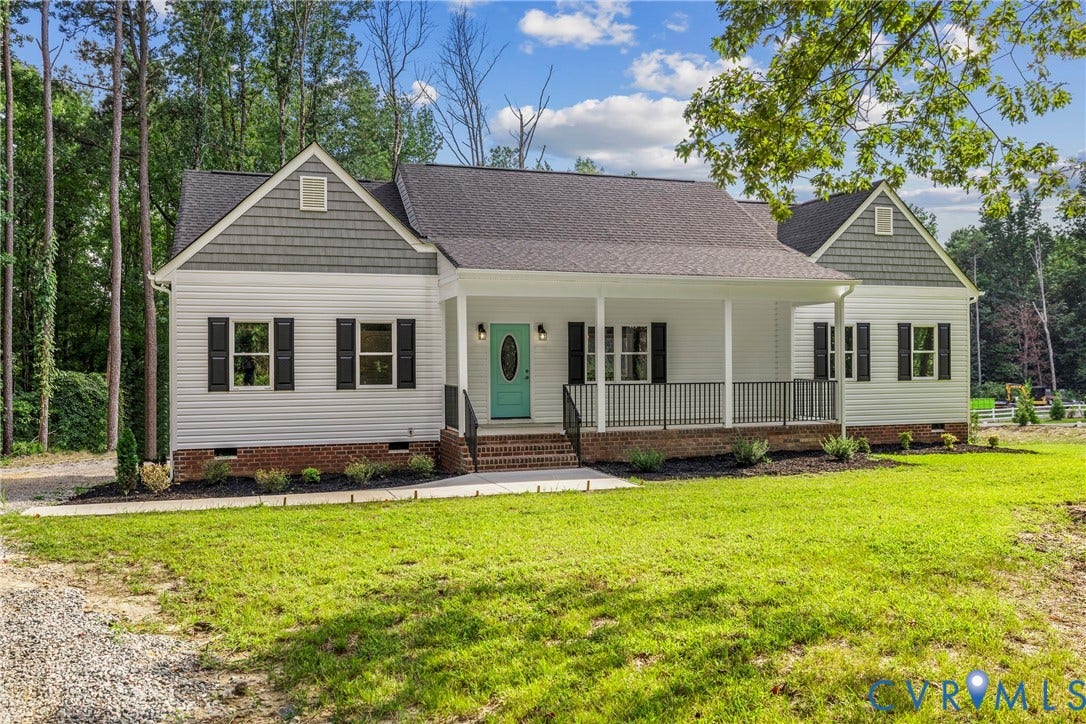Front porch with white columns and dark railing, teal front door, white siding, dark shutters, and gray shake siding accents