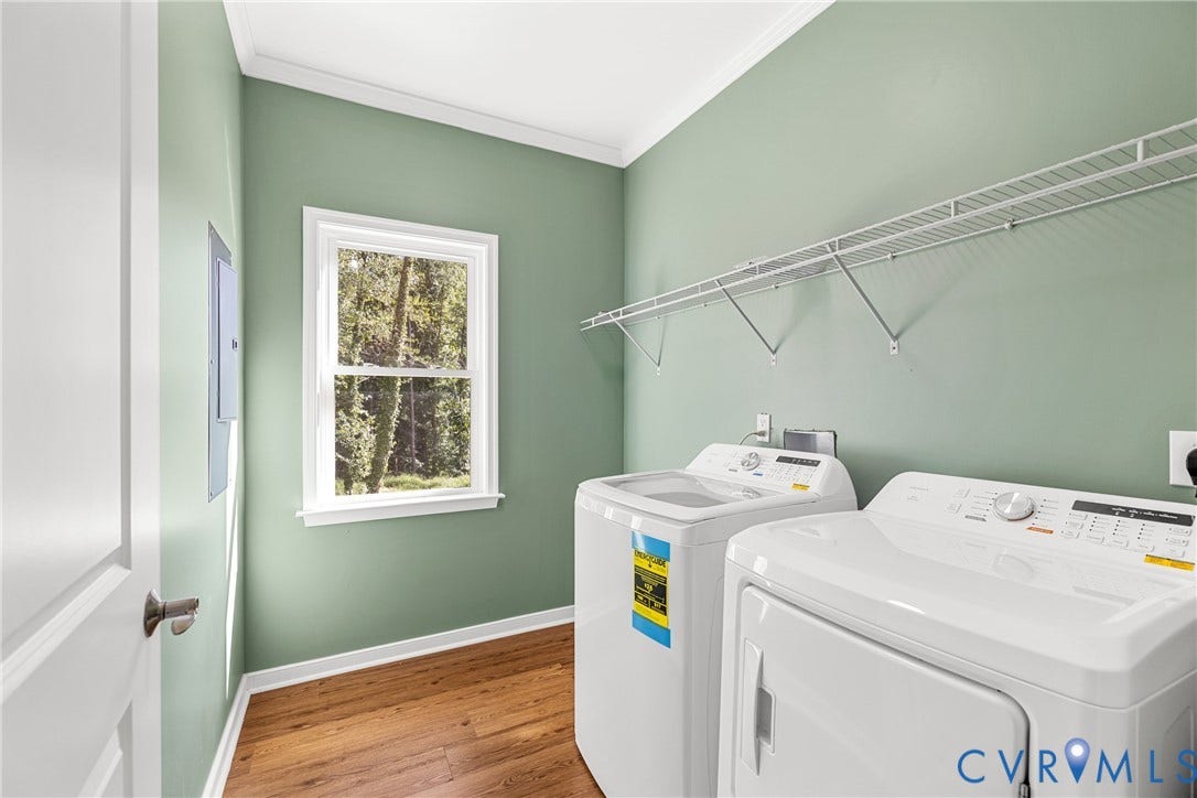 Laminate flooring with white trim, a single window, and a metal wire shelving system