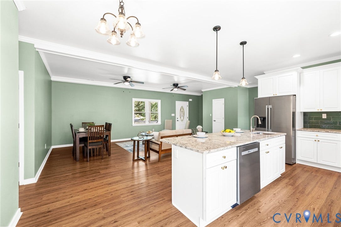 Open-concept kitchen into dining and living room areas