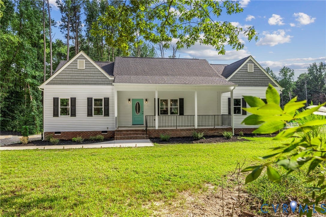 White siding exterior with a charcoal shingle roof, full covered front porch, and a vibrant teal entry door