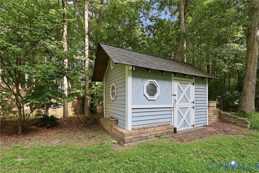 505 Martineau Drive, Chesterfield, VA 23836 Light blue shed with white trim, a dark shingle roof, double barn doors, and octagonal windows
