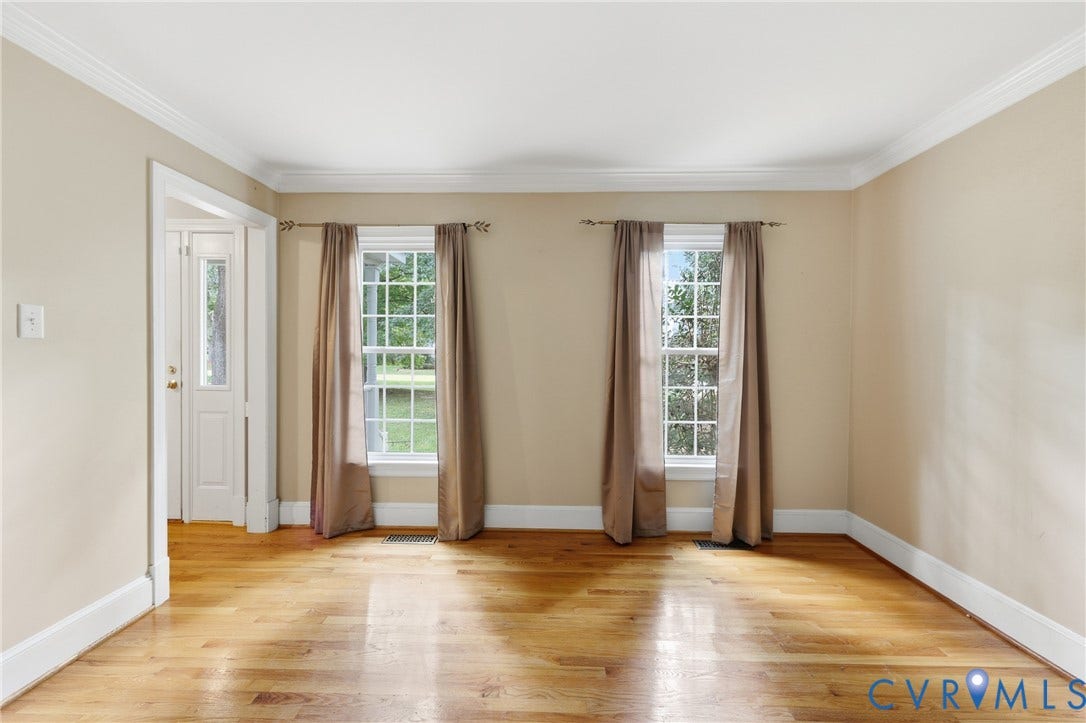 505 Martineau Drive, Chesterfield, VA 23836 Hardwood flooring, crown molding, two large windows, white trim, and a white door with a glass panel