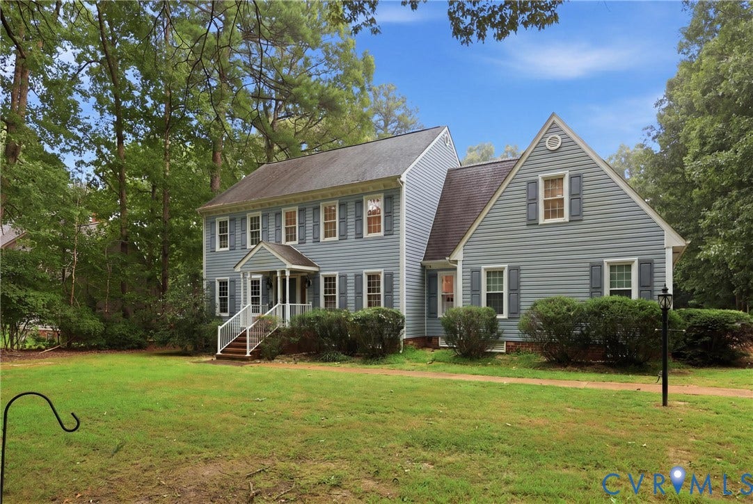 505 Martineau Drive, Chesterfield, VA 23836 Two-story residence with light blue siding, a covered porch, and mature surrounding trees