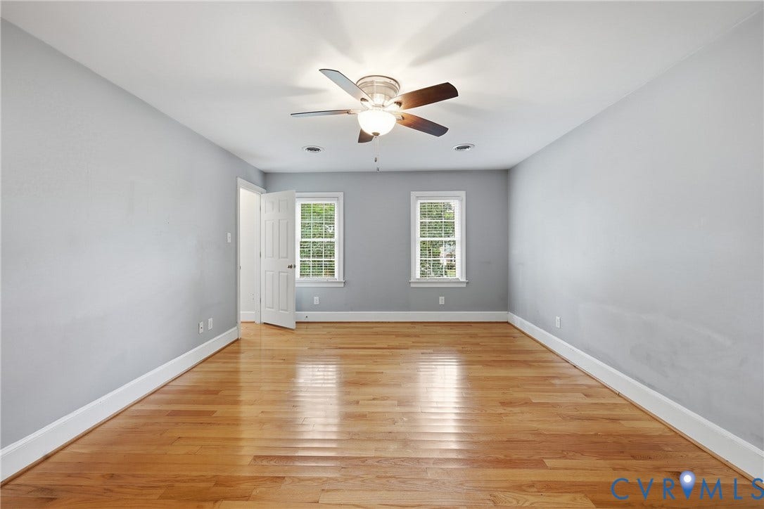 505 Martineau Drive, Chesterfield, VA 23836 Hardwood flooring, painted walls, two windows with white trim, and a ceiling fan with integrated lighting