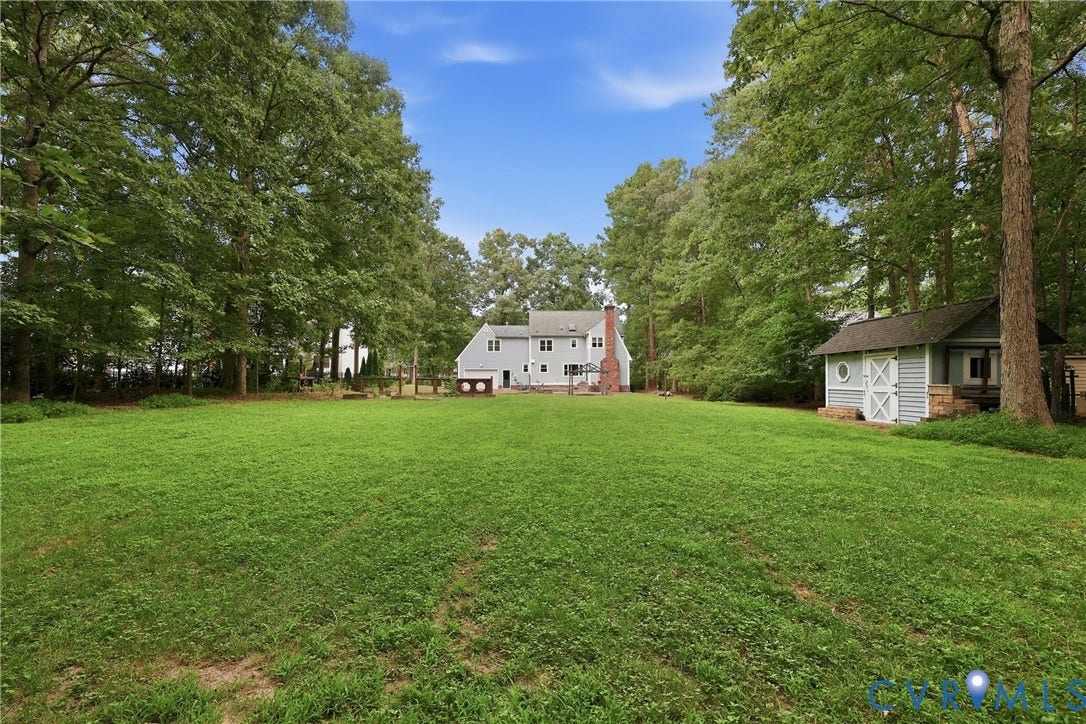 505 Martineau Drive, Chesterfield, VA 23836 Expansive green space featuring mature trees and a detached shed with double barn doors