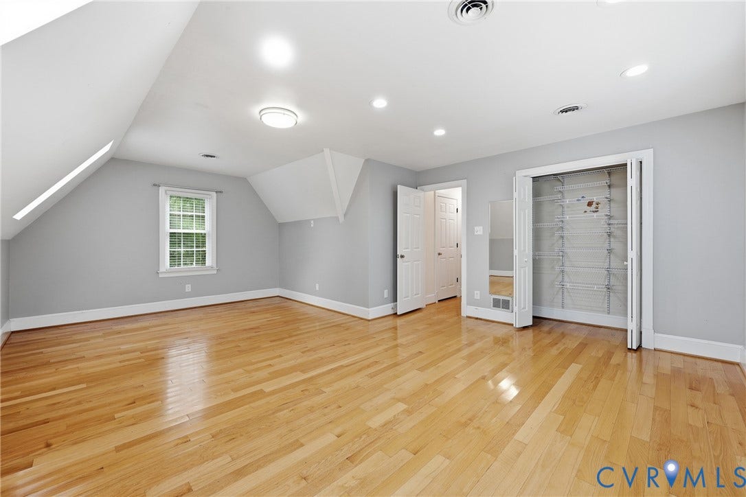 505 Martineau Drive, Chesterfield, VA 23836 Hardwood flooring, recessed lighting, double-hung window, white trim, and bi-fold closet doors with built-in shelving