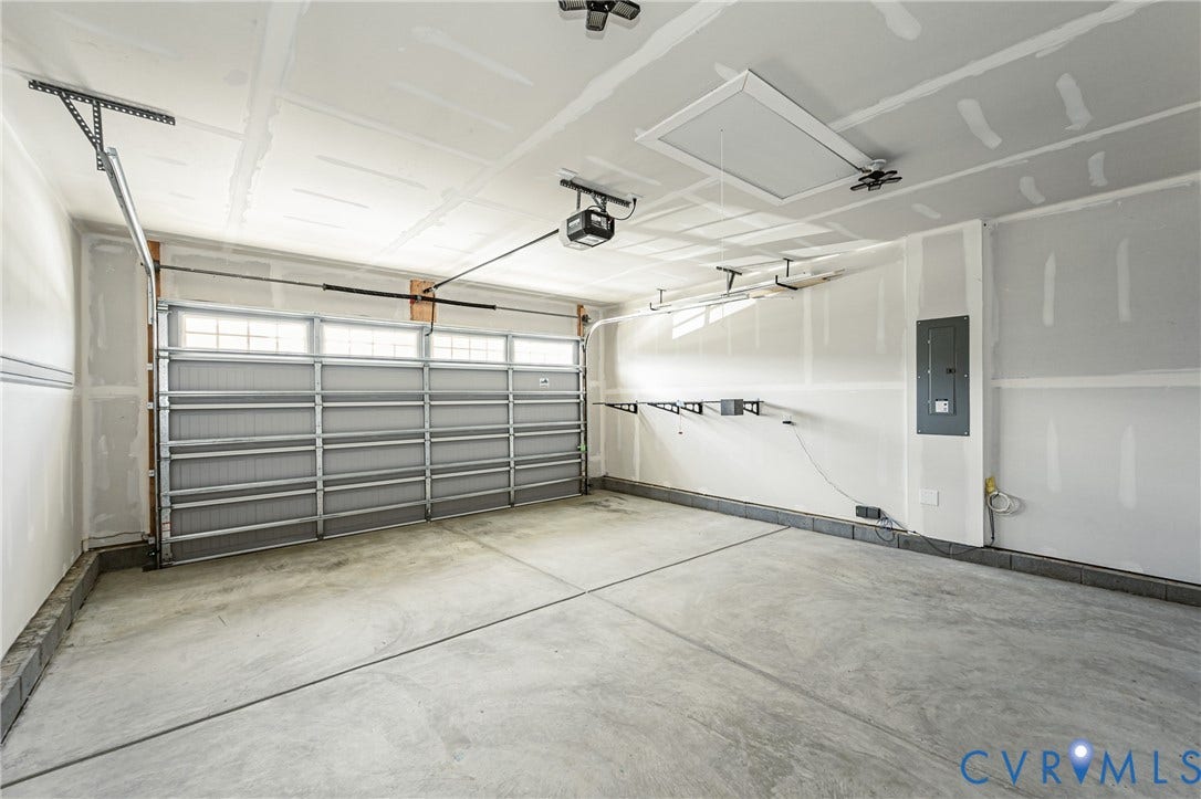 7683 Autumn Leaves Lane, Estates The Groves At New Kent, New Kent, VA 23124 Attached two-car garage with a concrete floor, automatic garage door opener, and integrated transom windows