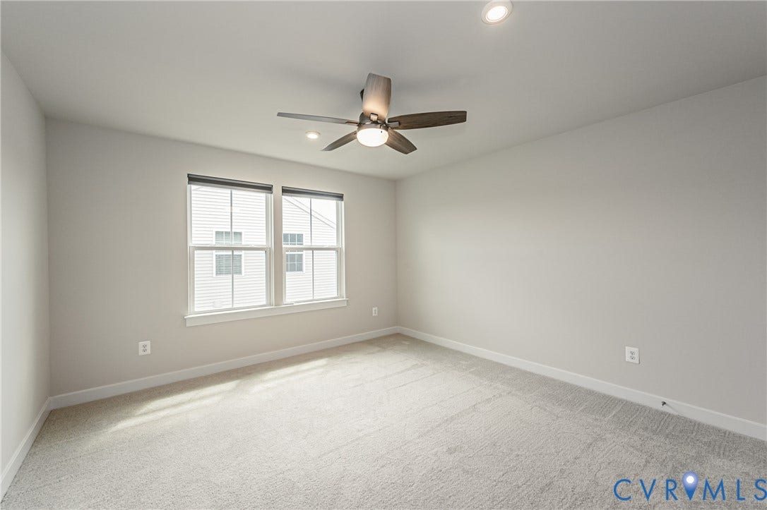7683 Autumn Leaves Lane, Estates The Groves At New Kent, New Kent, VA 23124 Dual windows with white trim, recessed lighting, ceiling fan with integrated light, light gray wall paint, and gray carpet flooring