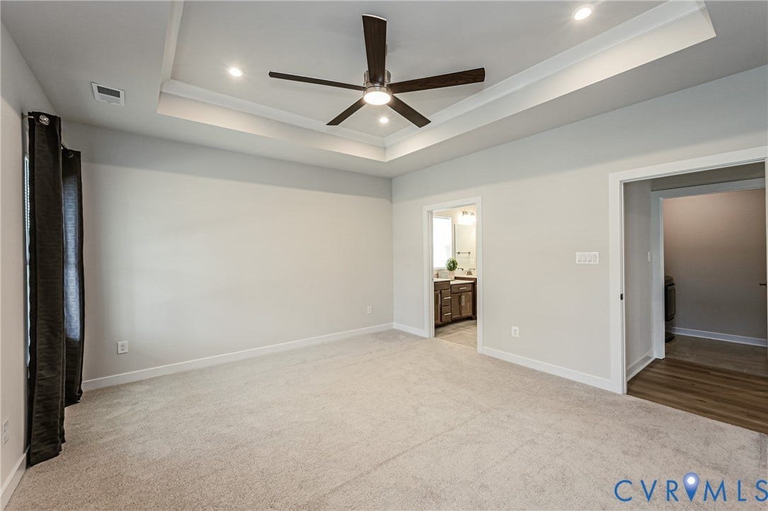 7683 Autumn Leaves Lane, Estates The Groves At New Kent, New Kent, VA 23124 Tray ceiling with recessed lighting, ceiling fan, and light gray wall paint