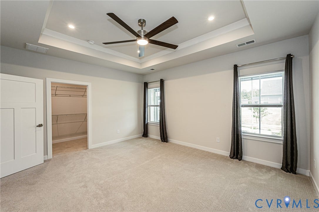 7683 Autumn Leaves Lane, Estates The Groves At New Kent, New Kent, VA 23124 Tray ceiling with recessed lighting and a ceiling fan, light-colored carpeting, and a walk-in closet with wire shelving
