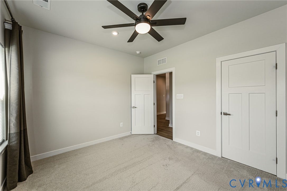 7683 Autumn Leaves Lane, Estates The Groves At New Kent, New Kent, VA 23124 Vaulted ceiling with a contemporary ceiling fan and recessed lighting, light-toned carpeting, and panel doors with dark hardware