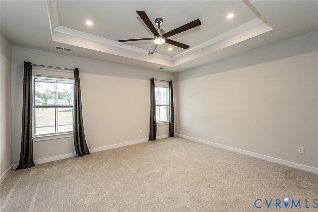 7683 Autumn Leaves Lane, Estates The Groves At New Kent, New Kent, VA 23124 Tray ceiling with recessed lighting and a ceiling fan, plush carpet flooring, and two windows