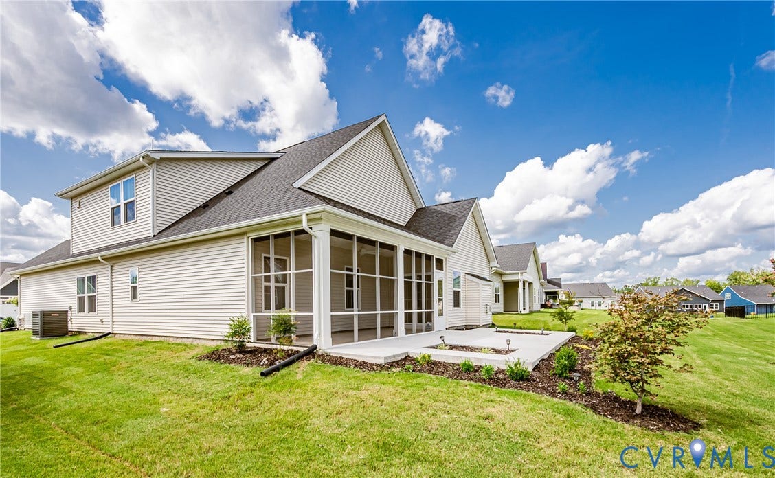 7683 Autumn Leaves Lane, Estates The Groves At New Kent, New Kent, VA 23124 Expansive backyard featuring a concrete patio, screened-in porch, and sloped lawn
