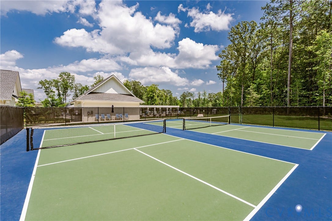 7683 Autumn Leaves Lane, Estates The Groves At New Kent, New Kent, VA 23124 Dual pickleball courts with perimeter fencing and a shaded seating area