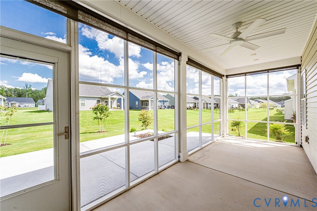 7683 Autumn Leaves Lane, Estates The Groves At New Kent, New Kent, VA 23124 Screened porch with concrete flooring, white ceiling fan, and white paneled ceiling