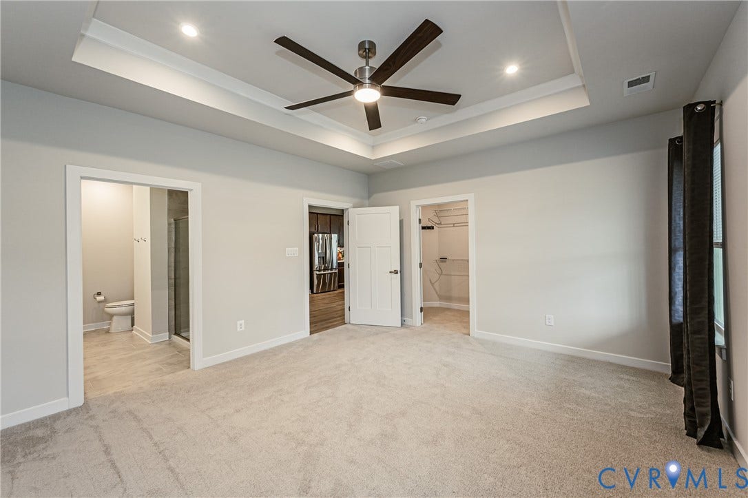7683 Autumn Leaves Lane, Estates The Groves At New Kent, New Kent, VA 23124 Tray ceiling with recessed lighting and a ceiling fan, light-toned carpet, and multiple doorways