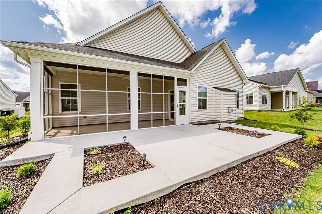 7683 Autumn Leaves Lane, Estates The Groves At New Kent, New Kent, VA 23124 Expansive screened patio with a concrete surface, complemented by a concrete walk and landscaped planting beds