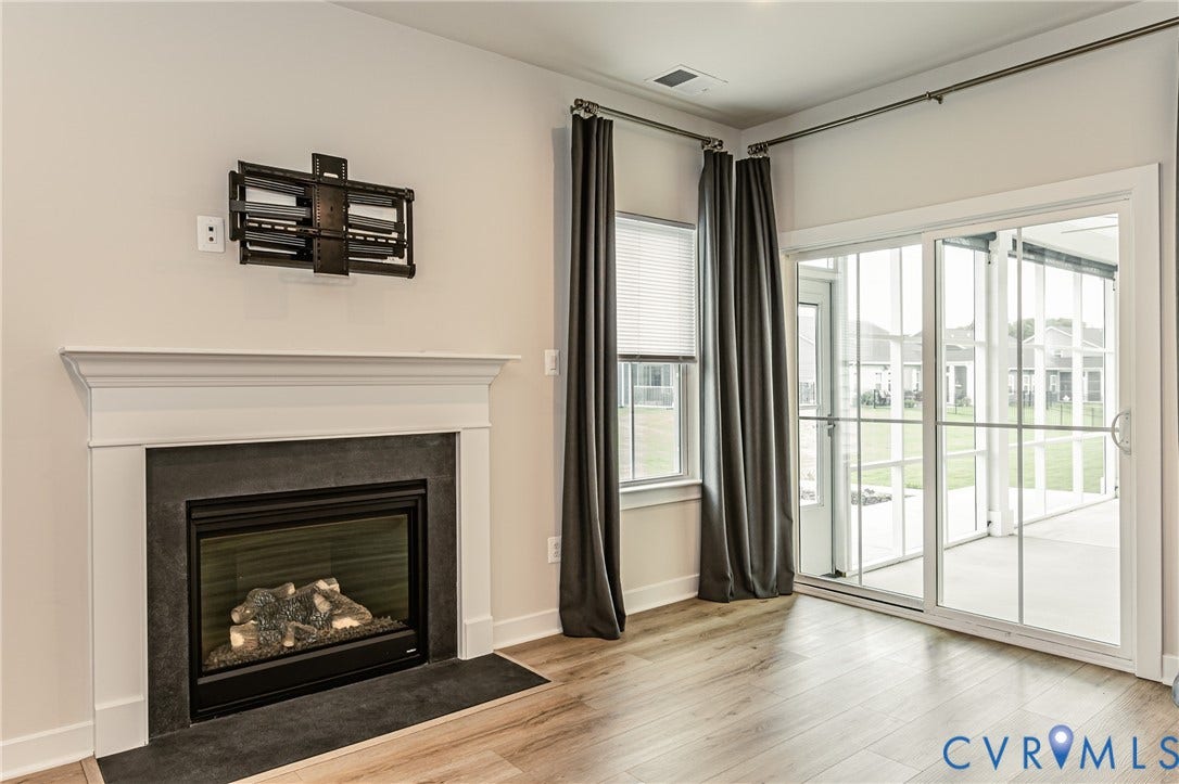 7683 Autumn Leaves Lane, Estates The Groves At New Kent, New Kent, VA 23124 Built-in fireplace with a stone-finish surround and wood mantel