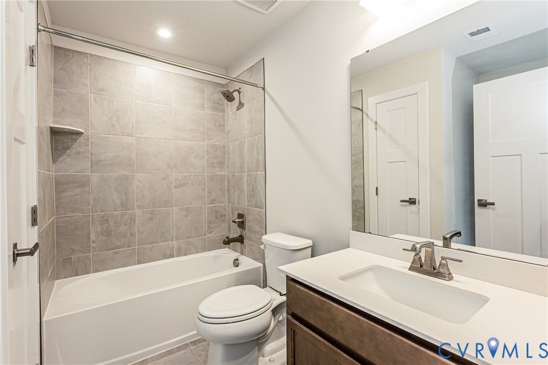 7683 Autumn Leaves Lane, Estates The Groves At New Kent, New Kent, VA 23124 Bathroom with a single vanity, undermount sink, and a framed mirror