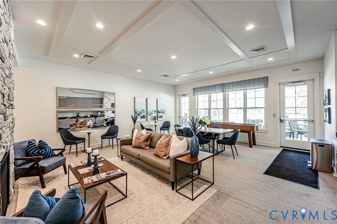 7683 Autumn Leaves Lane, Estates The Groves At New Kent, New Kent, VA 23124 Stone fireplace with a hearth, coffered ceiling, recessed lighting, expansive windows, and a glass-paneled door