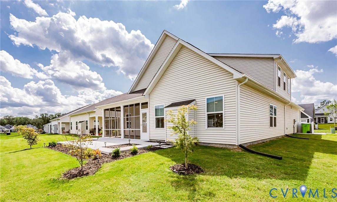 7683 Autumn Leaves Lane, Estates The Groves At New Kent, New Kent, VA 23124 Light-colored siding exterior with a screened-in porch, concrete patio, and landscaped planting beds